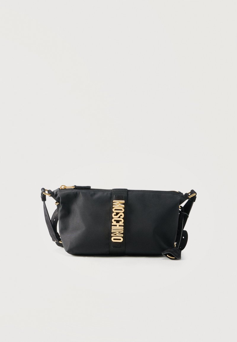 Black Moschino crossbody bag with gold zipper and gold letters on front strap, adjustable shoulder strap on light background.