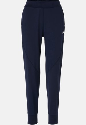 Calças de desporto azul marinho com uma cintura ajustada, pernas estreitas e painéis laterais; feitas de material flexível e respirável.