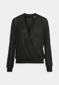 Haut enveloppant noir à manches longues avec un décolleté en V, fabriqué en tissu texturé, comportant des poignets et un ourlet côtelés, et une coupe ample et décontractée.