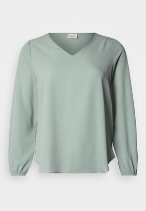 Blouse met V-hals en lange mouwen, gemaakt van zachte, gestructureerde stof, uitgevoerd in muntgroen met elastische manchetten voor een ontspannen pasvorm.