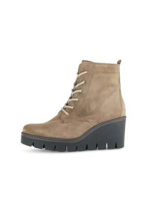 Beige suede ankle boot with a rounded toe, lace-up front, and a black wedge sole featuring a textured tread pattern.
