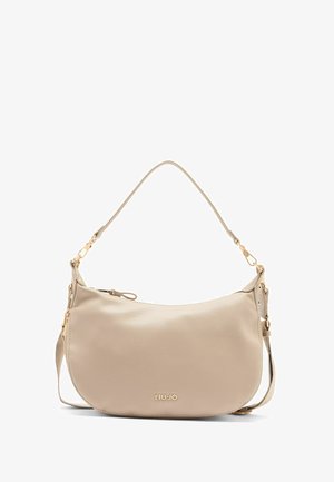 Sac à main en cuir beige avec une bandoulière et du matériel doré, présentant un logo de marque subtil à l'avant.
