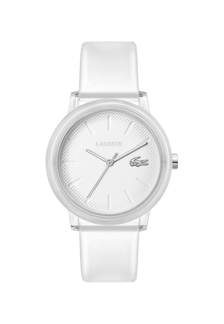 Reloj Lacoste blanco con caja transparente, esfera texturizada, agujas plateadas y una suave correa de silicona blanca. Diseño minimalista.