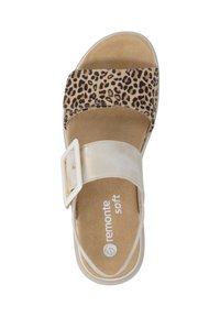 Leopard print sandal with a gold strap, a white buckle, and a flat, cushioned sole. Soft, textured upper material. Remonte brand logo visible.