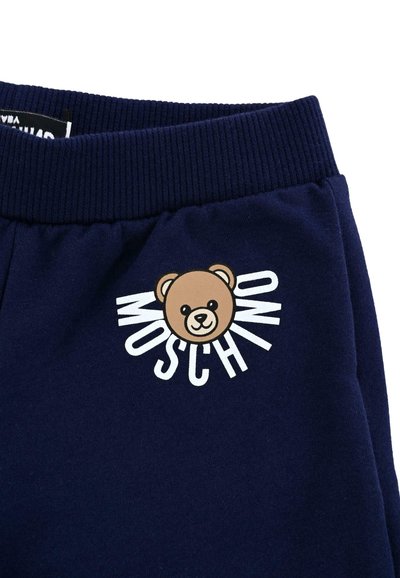 Navyblauwe sweatpants met een geribde tailleband, voorzien van een cartoonbeer en de tekst "MOSCHINO" in het wit, gedrukt op de linker dij.