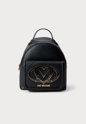 Black leather backpack with a rounded shape, featuring a gold-tone logo and accent. Includes a front zip pocket and top handle.