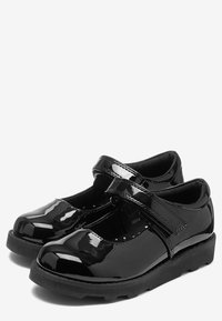 Zwarte patenten leer Mary Jane-schoenen met een verstelbare band, ronde neus en gestructureerde rubberen zool. Glad oppervlak en gevoerd interieur.