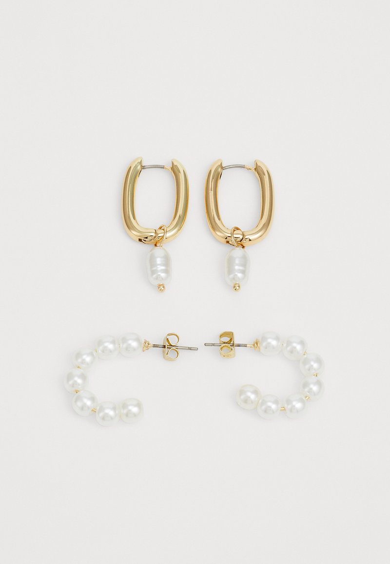 Gold-tone hoop earrings with a smooth surface and a single white pearl drop, paired with a curved pearl stud earring design.