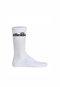 Calzino sportivo bianco in cotone con texture a costine, caratterizzato da un logo "ellesse" nero in cima e una zona della punta rinforzata.