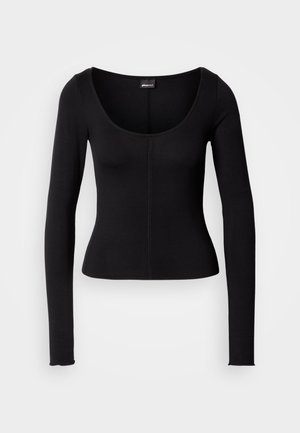 Svart langermet topp med rund hals, tettsittende design og vertikale sømmer midt foran. Laget av et glatt stoff.