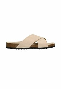 Beige suede cross-strap slide sandal with a cork footbed and black scalloped rubber sole. Minimalistic design with a smooth texture.