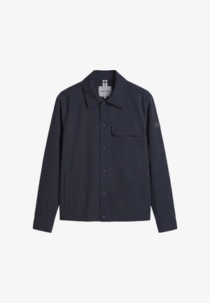 Veste boutonnée bleu marine avec col, poche poitrine à rabat, poches latérales et écusson logo "AM" sur la manche gauche.