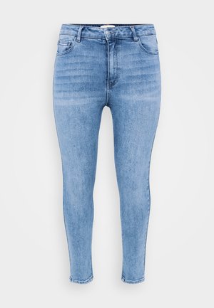 Svijetloplavi skinny traperice izrađene od denima, s visokim strukom, pet džepova i blagim izblješnjenjem duž bedara.