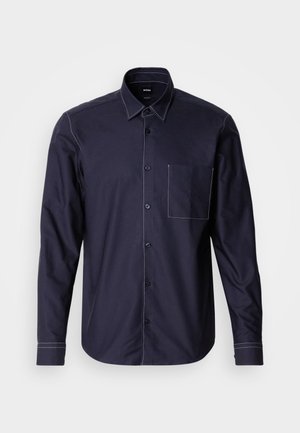 Tengeri gombos ing pamut keverékből, fehér kontrasztos varrással, mellzsebből és klasszikus gallér kialakítással.