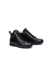 Bottines en cuir noir avec œillets métalliques, lacets contrastants, semelle texturée et fermeture éclair sur le côté pour un accès facile.