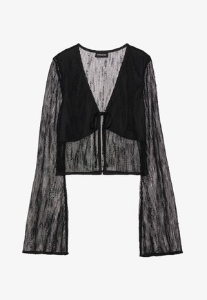 Top corto negro hecho de tela de malla transparente. Cuenta con un cierre de lazo en la parte delantera y mangas largas acampanadas con un patrón texturizado.