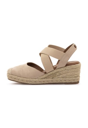 Sandalia cuña espadrille beige con tacón envuelto en yute, con parte superior de suave ante y tiras elásticas cruzadas para mayor estabilidad.