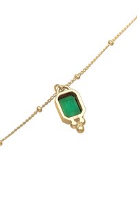 Collar de oro que presenta un colgante geométrico con un gemstone verde rectangular. La cadena es retorcida e incluye pequeños acentos esféricos.