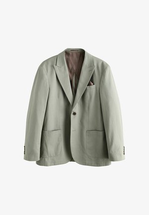 Svetlozelený blazer s výrezmi na lapeloch, dvoma prednými vreckami a zapínaním na gombík. Podšitý hnedým interiérom a má dekoratívne stehy.