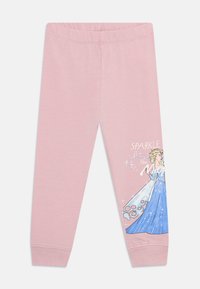 Lichtroze legging met een zachte textuur, voorzien van een afbeelding van een karakter in een blauwe jurk, en de woorden "SPARKLE like" ernaast gedrukt.
