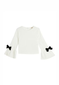 Top bianco a maniche lunghe con costine e maniche a campana, caratterizzato da dettagli in nero a forma di fiocco ai polsini. Chiusura sul retro del collo.