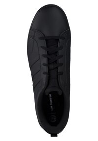 Zapatilla deportiva negra con un acabado mates liso, que presenta un diseño con cordones, punta curva y franjas laterales. En el interior tiene un mensaje impreso.