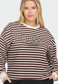 Brūnas un krēmus svītrainā sporta jakā ar apaļu kakla izgriezumu, ar pērlītēm izšūtu "BLISS" tekstu un iedvesmojošu citātu zem tā. Mīksts audums.