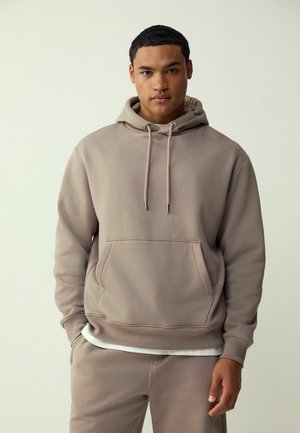 Hooded sweatshirt in light beige, cotton blend fabric. Features a front pocket and drawstrings, with ribbed cuffs and hem. Paired with matching pants.