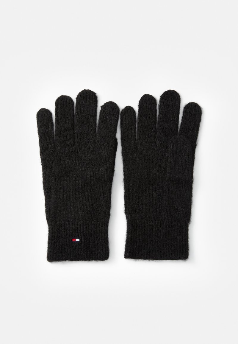 Sorte strikkede handsker med fem fingre og en ribbet cuff. Har et lille tri-farvet logo nær håndleddet. Blødt og tekstureret materiale.
