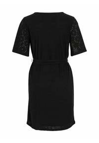 Svart klänning med korta ärmar, rund urringning och ett bälte i midjan. Har ögla-mönster på ärmarna och ett mjukt, texturerat tyg.