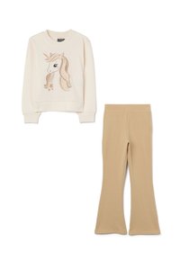 Felpa crema con grafica di un unicorno e dettagli dorati, abbinata a pantaloni beige a zampa d'elefante, entrambi realizzati in tessuto morbido.