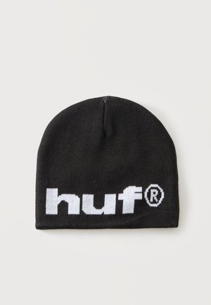 Bonnet en tricot noir avec un logo blanc audacieux "huf" et le symbole de marque déposée à l'avant, présenté sur un fond clair uni.