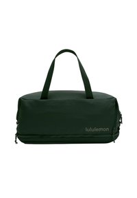 Zielona torba sportowa o gładkiej, teksturowanej powierzchni, z podwójnymi uchwytami i zamkiem błyskawicznym. Logo umieszczone z boku.