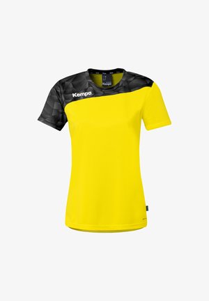 Maillot de sport jaune avec un motif géométrique noir sur les épaules et les manches, arborant le logo « Kempa » sur la poitrine.
