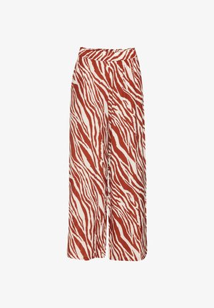 Kalhoty s širokými nohavicemi v pruhovaném vzoru zebry v rezavé a bílé barvě, s vysokým pasem a hladkým, lehkým materiálem.
