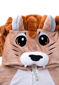 Tan and orange plush lion hooded garment with large eyes, whiskers, and teeth details. Soft texture, zip closure, and care tag visible.