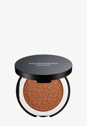 Bronzer compact dans un boîtier rond noir, contenant une poudre brun clair gravée du nom de la marque. La base a un contour blanc.