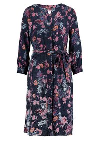 Marinblå blommig klänning med prickigt mönster, långa ärmar, V-ringning, knytmidja och knälång fåll. Har rosa, vita och blå blommiga detaljer.