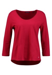 Maglietta rossa a maniche lunghe realizzata in tessuto morbido, con scollatura a barchetta e orlo curvato. Design semplice senza pattern o decorazioni.