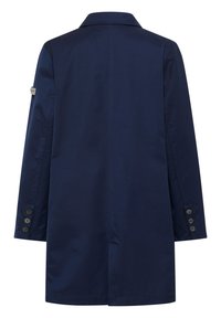Navy blauwe jas van gladde stof, met een klassieke kraag, lange mouwen en vijf zwarte knopen op de manchetten. Eenvoudig, gestroomlijnd ontwerp.