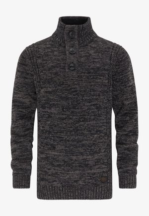 Pull-over en maille chinée gris foncé. Il présente un col montant, trois grands boutons, des poignets et un ourlet côtelés. Tissu texturé avec un motif remarquable.