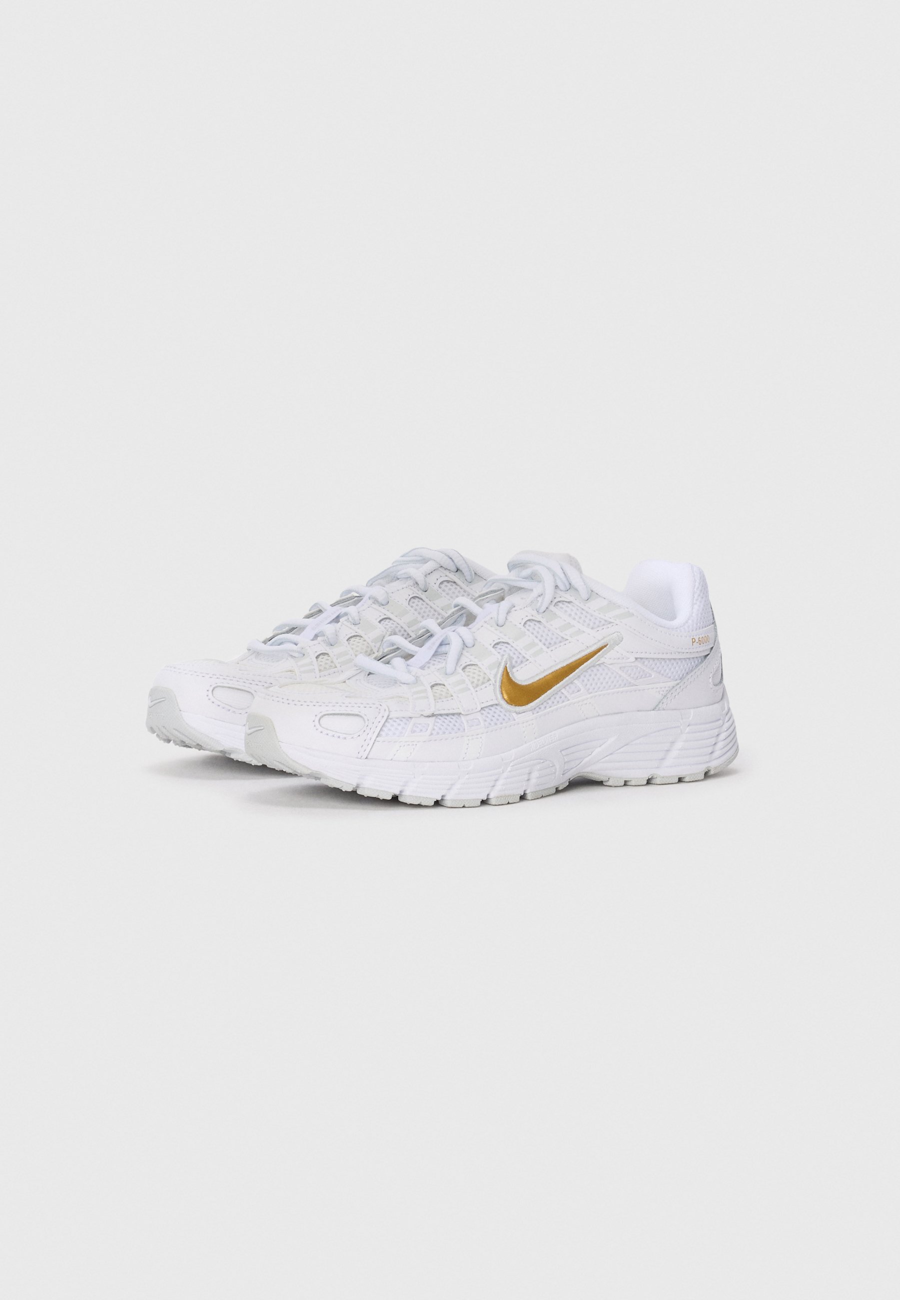 white nike shoes with gold swoosh
