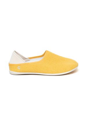 Yellow canvas slip-on shoe with a white accent at the heel, rounded toe, flat sole, and textured fabric. Features subtle branding on the side.
