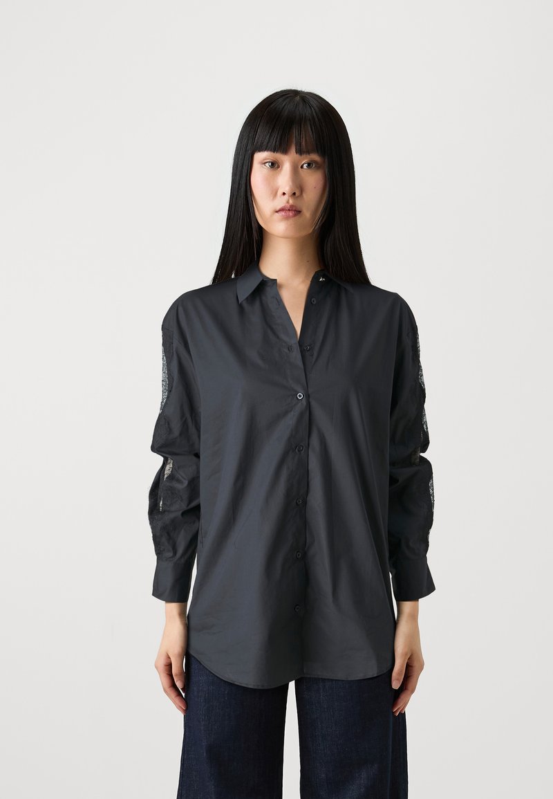 Dark gray shirt with a button-down front, long sleeves featuring lace accents, and a relaxed fit. Made of smooth fabric with a collar.