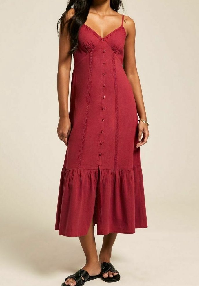 Maroon midi dress with spaghetti straps, button front, lace detailing, and flared ruffled hem. Smooth texture, casual fit.