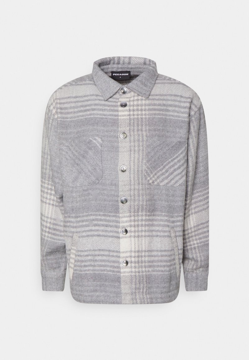 Camicia a quadri grigia e crema in un morbido tessuto spazzolato. Presenta una chiusura con bottoni, due tasche sul petto e un colletto classico.
