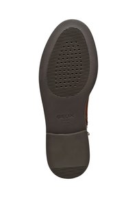 Brown Geox shoe sole featuring textured rubber with grooves and perforations, oval shape, branded "Geox" and "Italian Patent."