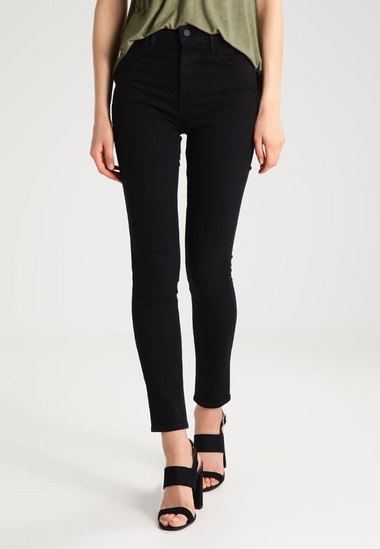 Jeans skinnies negros de denim con una cintura alta, que presentan un diseño clásico de cinco bolsillos y un ligero estiramiento para mayor comodidad.