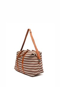 Woven fabric bag featuring a zigzag pattern in cream, brown, and rust, with contrasting brown leather handles and zipper accents.