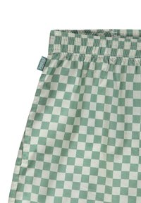 Tessuto a quadri verde e crema con motivo a scacchi. Presenta un elastico in vita e una piccola etichetta con il marchio sul lato.